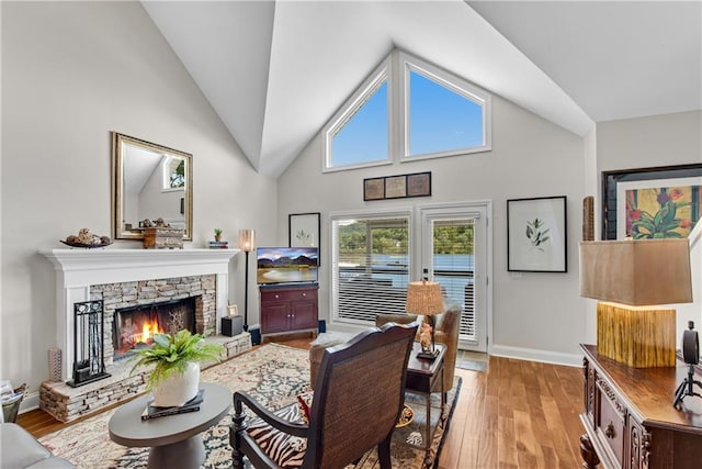 2176 Pine Lake Rd, Hiawassee, GA 30546 - living area with light wood finished floors, high vaulted ceiling, a fireplace, and baseboards