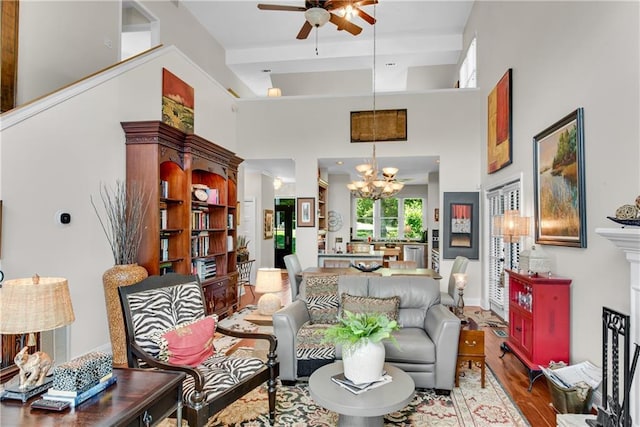 2176 Pine Lake Rd, Hiawassee, GA 30546 - living area with ceiling fan, a chandelier, wood finished floors, and a high ceiling