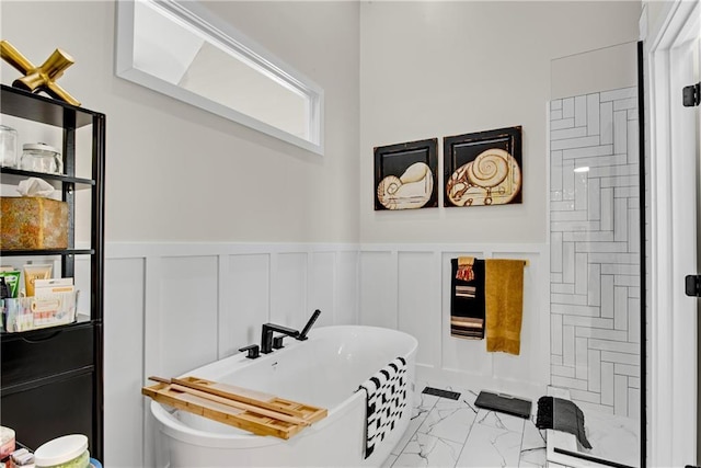 2176 Pine Lake Rd, Hiawassee, GA 30546 - full bathroom with marble look tiles, a freestanding bath, a decorative wall, and wainscoting