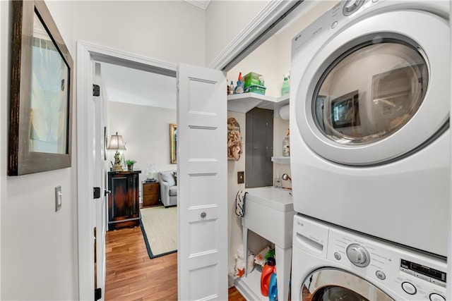 2176 Pine Lake Rd, Hiawassee, GA 30546 - washroom with stacked washer and clothes dryer and light wood-style flooring
