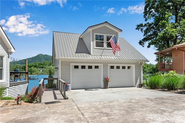 2176 Pine Lake Rd, Hiawassee, GA 30546 - view of front of property featuring a garage, concrete driveway, a mountain view, and metal roof
