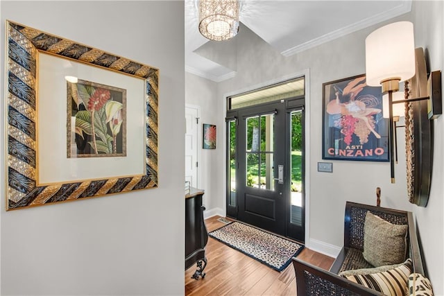 2176 Pine Lake Rd, Hiawassee, GA 30546 - foyer featuring wood finished floors, ornamental molding, a chandelier, and baseboards