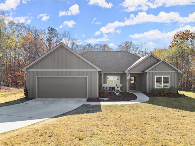 view of front of home with a front yard and a garage