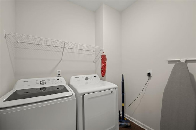 clothes washing area featuring washer and dryer