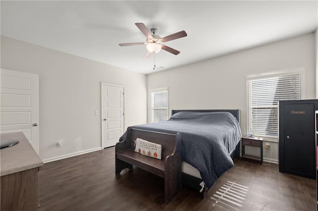 bedroom featuring multiple windows, ceiling fan, and dark hardwood / wood-style floors