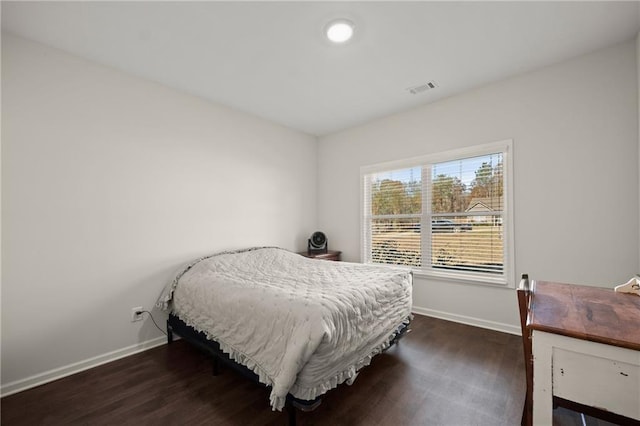 bedroom with a closet and dark wood-type flooring