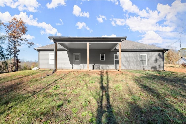 rear view of house with a lawn