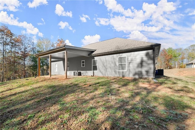 rear view of house featuring a lawn