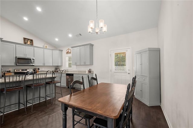 dining area featuring a chandelier, dark hardwood / wood-style flooring, and vaulted ceiling