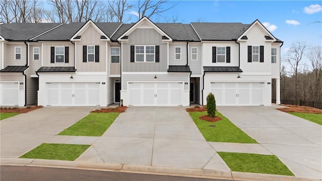 353 Sound Cir, Stockbridge, GA 30281 - view of front facade with an attached garage, a standing seam roof, and driveway