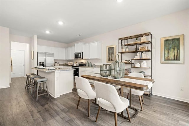 353 Sound Cir, Stockbridge, GA 30281 - dining room with baseboards, dark wood-type flooring, and recessed lighting