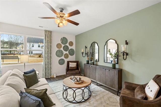 353 Sound Cir, Stockbridge, GA 30281 - living area with wood finished floors, visible vents, a ceiling fan, and baseboards