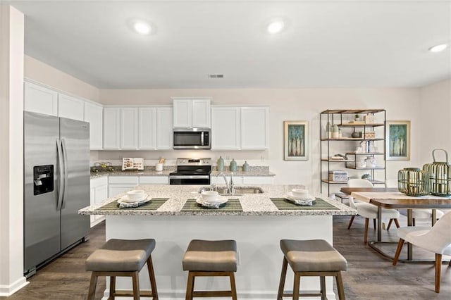 353 Sound Cir, Stockbridge, GA 30281 - kitchen featuring visible vents, stainless steel appliances, dark wood-style floors, and a sink