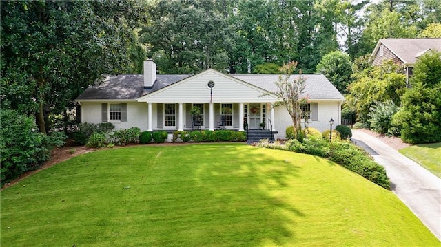 ranch-style house with covered porch and a front yard