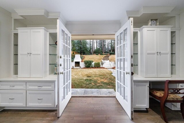 doorway to outside with dark hardwood / wood-style floors, crown molding, and french doors