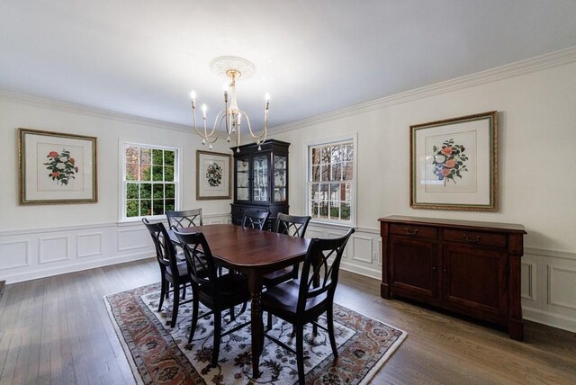 dining area featuring a notable chandelier, crown molding, and dark hardwood / wood-style floors