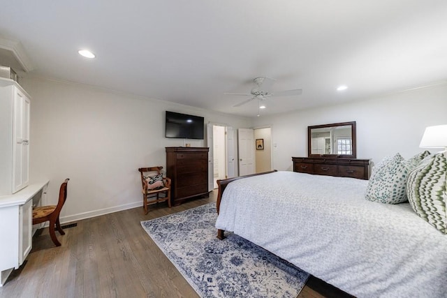 bedroom with dark wood-type flooring, ceiling fan, and crown molding