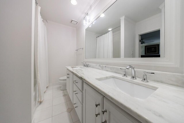 bathroom with toilet, crown molding, tile patterned floors, and vanity