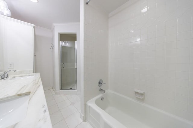 bathroom with vanity, tiled shower / bath combo, tile patterned floors, and crown molding