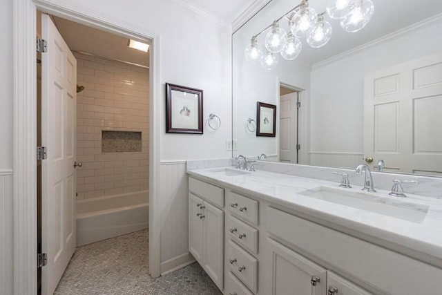 bathroom with vanity, tile patterned flooring, ornamental molding, and tiled shower / bath