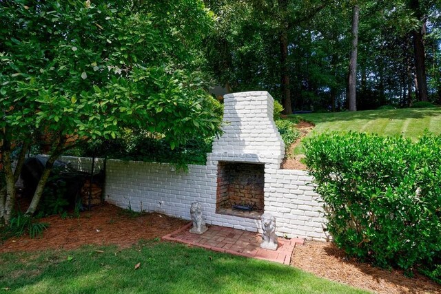 exterior space featuring an outdoor brick fireplace