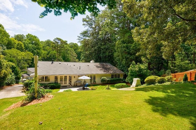 rear view of property with a yard and a patio