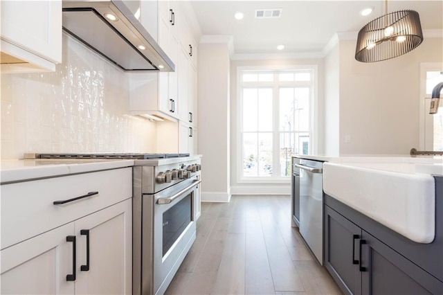 530 Fisher Dr Unit 45, Alpharetta, GA 30009 - kitchen with stainless steel appliances, custom exhaust hood, crown molding, recessed lighting, and light countertops