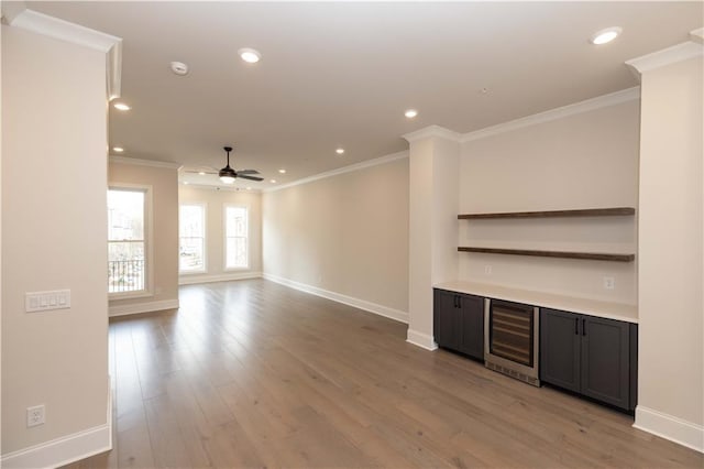 530 Fisher Dr Unit 45, Alpharetta, GA 30009 - unfurnished living room featuring beverage cooler, crown molding, a ceiling fan, baseboards, and light wood finished floors
