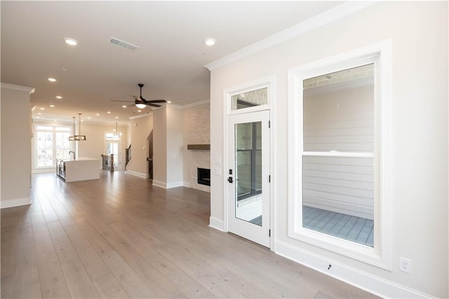 530 Fisher Dr Unit 45, Alpharetta, GA 30009 - unfurnished living room with crown molding, a large fireplace, a ceiling fan, light wood-type flooring, and baseboards