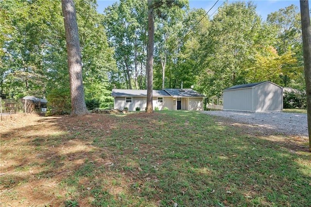 ranch-style house with a front lawn and a storage unit