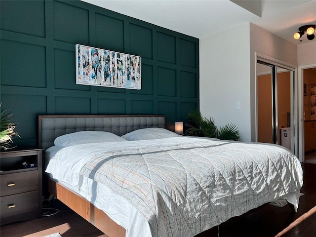 bedroom with a closet and dark wood-type flooring