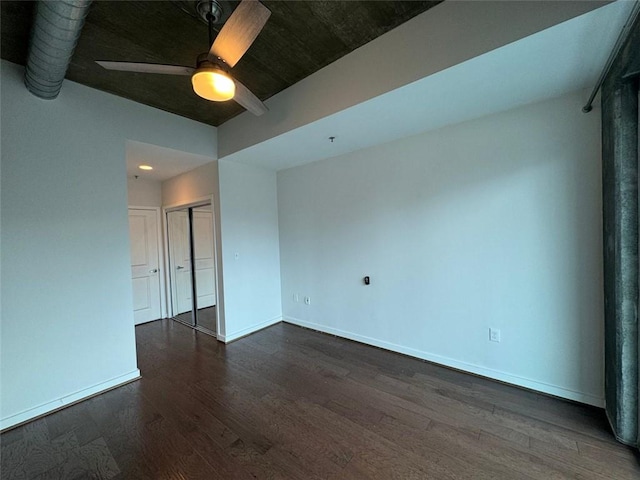 spare room with ceiling fan and dark wood-type flooring