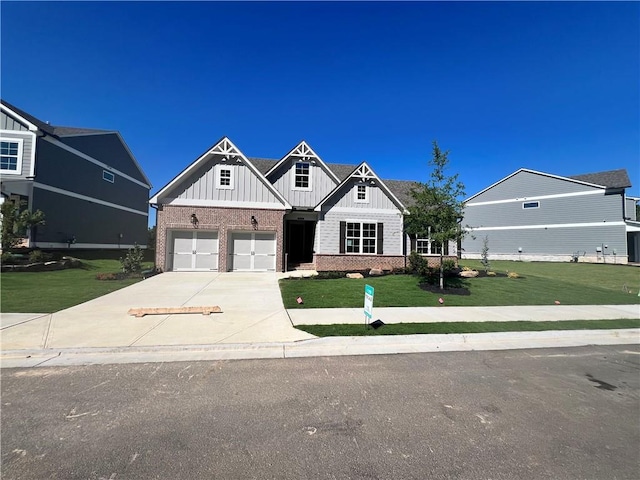 view of front of property with a front yard and a garage