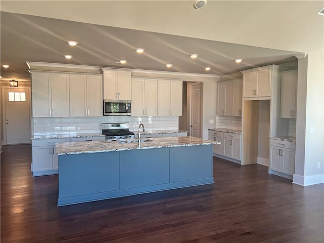 kitchen with white cabinets, stainless steel appliances, dark hardwood / wood-style flooring, and decorative backsplash