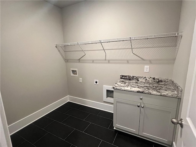 laundry area with hookup for a washing machine, dark tile patterned floors, and hookup for an electric dryer