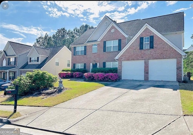 665 Roxford Ln, Buford, GA 30518 - view of front of house with brick siding, concrete driveway, a garage, and a front yard