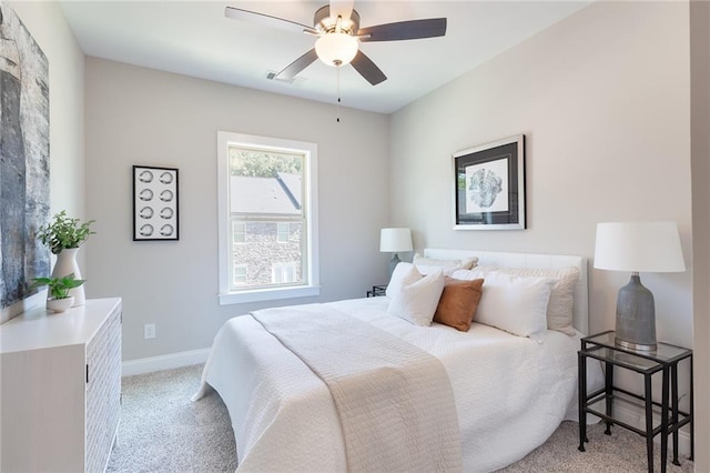 bedroom featuring visible vents, baseboards, a ceiling fan, and light colored carpet