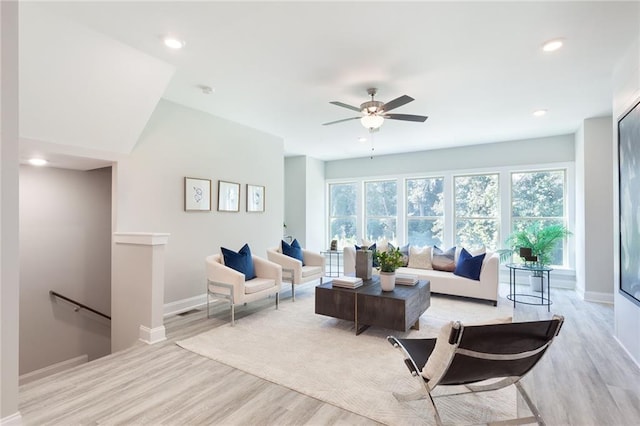 living room with baseboards, recessed lighting, and light wood-style floors