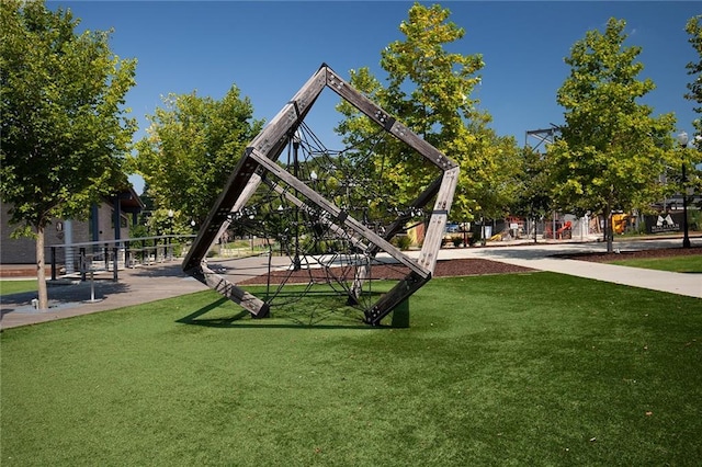 view of property's community featuring a yard and playground community