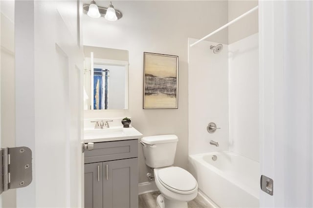 full bath featuring baseboards, vanity, toilet, and shower / bathtub combination