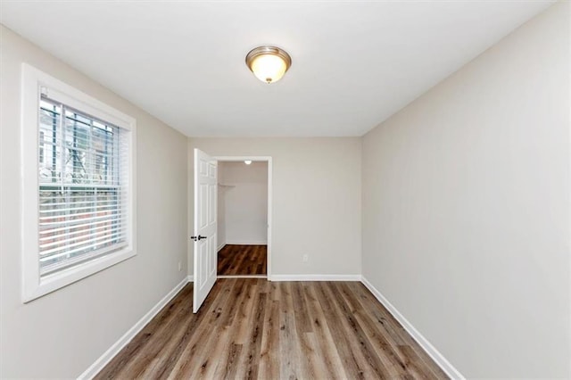 unfurnished room featuring light wood-style floors and baseboards