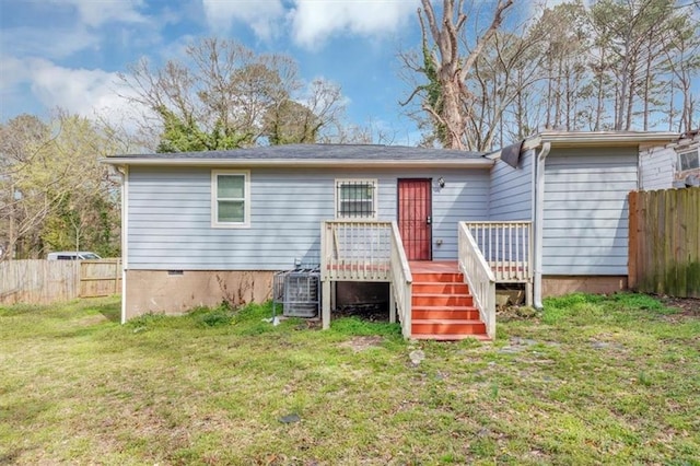 rear view of house featuring fence, a yard, a wooden deck, crawl space, and central AC unit