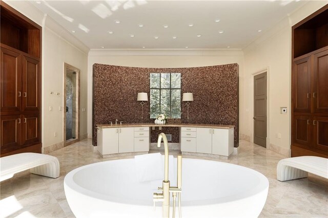 bathroom with a shower stall, a soaking tub, marble finish floor, and ornamental molding