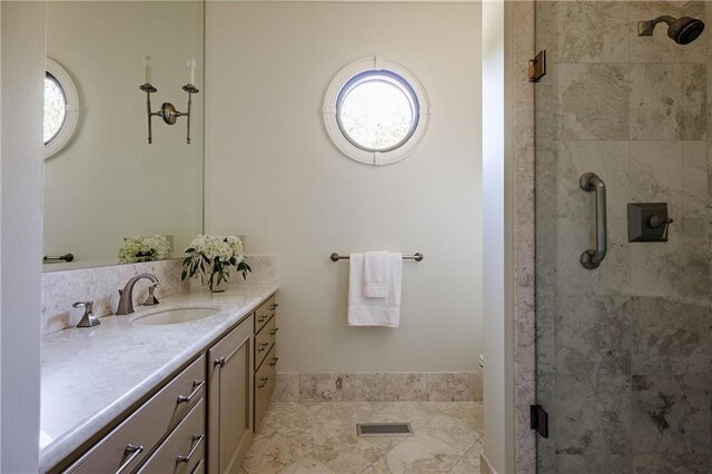 bathroom featuring a stall shower, vanity, visible vents, and a wealth of natural light
