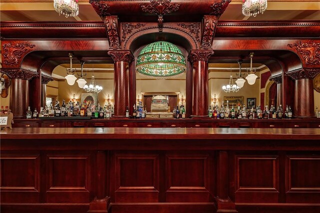 bar featuring a dry bar and an inviting chandelier