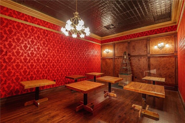 miscellaneous room featuring ornamental molding, a chandelier, hardwood / wood-style floors, wallpapered walls, and an ornate ceiling