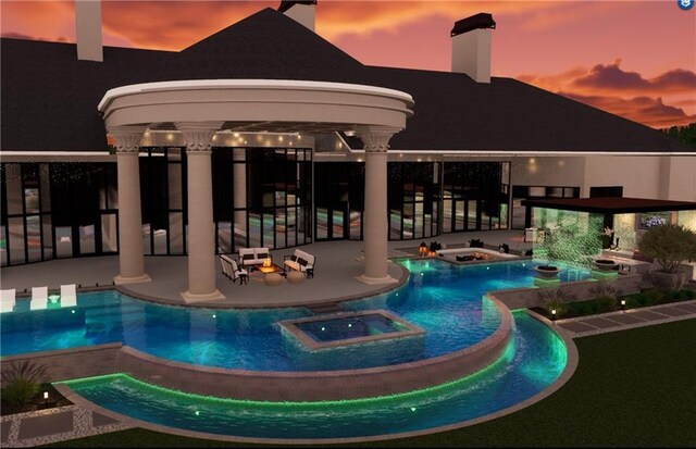 view of pool featuring a patio and a pool with connected hot tub