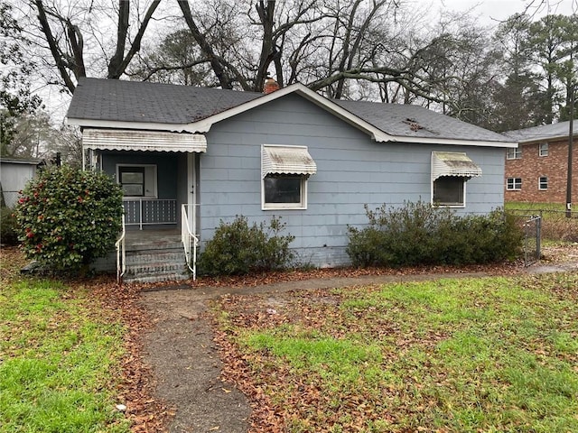 view of front of home with a porch and fence