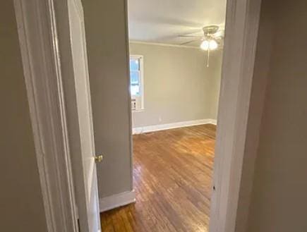 hall with dark wood finished floors and baseboards