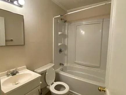 bathroom featuring shower / bath combination, toilet, crown molding, and vanity